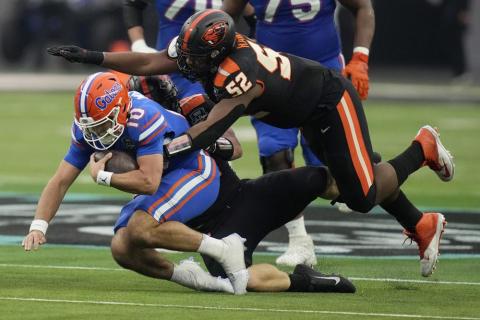 Oregon State defensive lineman James Rawls (52) jumps on Florida quarterback Jack Miller III (10) during the Las Vegas Bowl on Saturday in Las Vegas. (JOHN LOCHER/Associated Press)