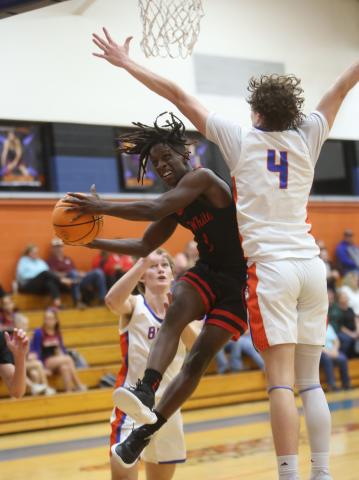 Fort White guard Najeeb Smith drives to shoot while being defend by Branford guard Camden Gaskins on Thursday night. (PAUL BUCHANAN/Special to the Reporter)