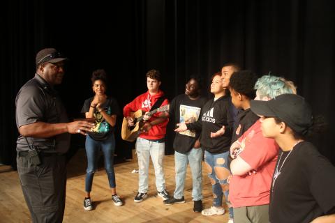 Ronnie Collins (from left), Columbia’s Top Talent competition founder and sponsor, talks to contestants Di’Amee Reese, AJ Busscher, Omarion Howard, Michelle Burch, Omarion Udell, Jacqueline Wiley, Ash Esposito and Jaleiah Burch as they prepare to compete in the first round of competition on Friday night at the Norman Choice Performing Arts Auditorium on the Columbia High School campus. (TONY BRITT/Lake City Reporter)