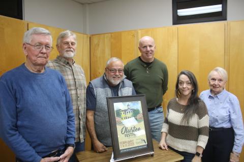 John Larner (from left) stands with members of the Blue-Grey Army Tom Coleman, Tony Buzzella, Sean McMahon, Sheila Carr (representing the Gateway Art Gallery) and Faye Bowling Warren on Tuesday night as the 44th Annual Olustee Battle Festival poster was unveiled. Larner created the painting that will be used of the event poster. (TONY BRITT/Lake City Reporter)