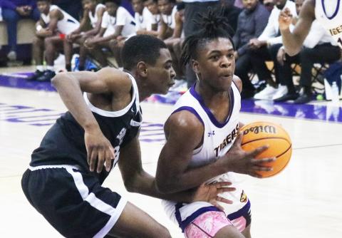 Columbia guard Zamarion Jones drives to the basket while Santa Fe guard Braylon Guyden defends on Friday night. (JORDAN KROEGER/Lake City Reporter)