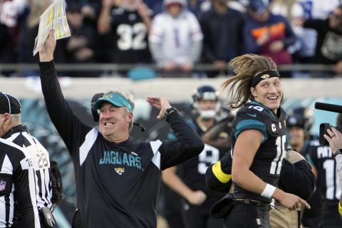 Jacksonville Jaguars head coach Doug Pederson (left) celebrates with Jacksonville Jaguars quarterback Trevor Lawrence (16) after defeating the Dallas Cowboys in overtime on Sunday in Jacksonville. (JOHN RAOUX/Associated Press)