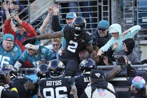 Jacksonville Jaguars safety Rayshawn Jenkins (2) celebrates with fans after his interception return for a touchdown against the Dallas Cowboys on Sunday in Jacksonville. (JOHN RAOUX/Associated Press)