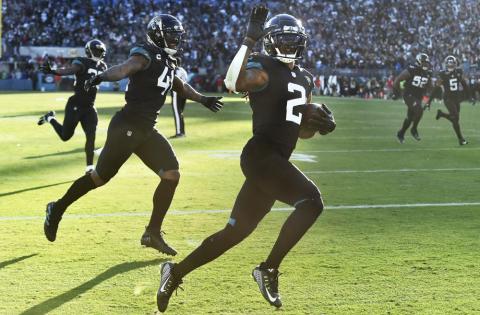Jacksonville Jaguars safety Rayshawn Jenkins (2) celebrates with linebacker Josh Allen (41) and linebacker Devin Lloyd (33) after his game-winning pick-6 against the Dallas Cowboys in overtime on Sunday in Jacksonville. (BOB SELF/The Florida Times-Union via AP)