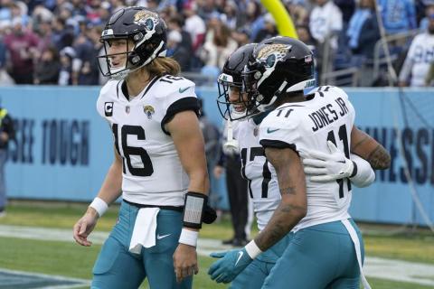 Jacksonville Jaguars tight end Evan Engram runs with the ball as Tennessee Titans safety Andrew Adams (47) and linebacker Bud Dupree (48) defend during Sunday's game in Nashville, Tenn. (CHRIS CARLSON/Associated Press)
