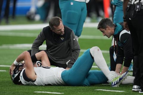 Jacksonville Jaguars quarterback Trevor Lawrence is examined after a sack during Sunday's game against the Detroit Lions in Detroit. (PAUL SANCYA/Associated Press)