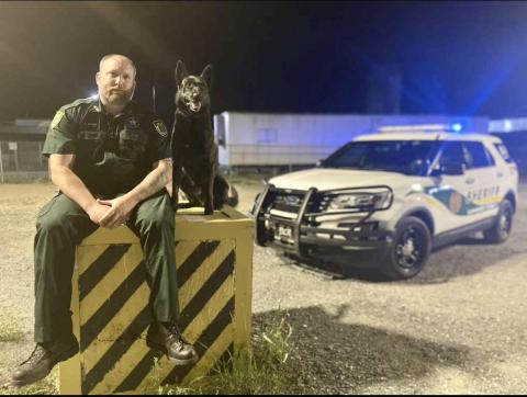 Suwannee County Sheriff’s Office Cpl. Justin Stout sits with K-9 Officer Loki. Loki passed away yesterday morning after being diagnosed with cancer. (COURTESY)