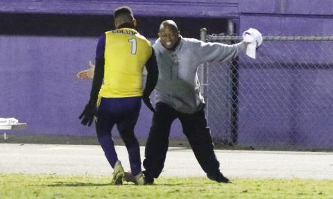 Columbia’s AJ Brinson (1) celebrates with head coach Ed Turner after scoring his first goal against Eastside on Friday night. (MORGAN MCMULLEN/Lake City Reporter)