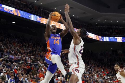 Florida guard Kowacie Reeves goes up for a shot as Auburn guard Allen Flanigan defends on Wednesday in Auburn, Ala. (BUTCH DILL/Associated Press)