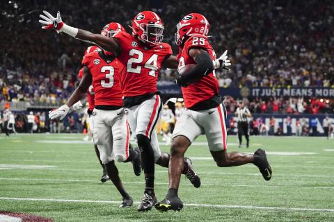 Georgia defensive back Malaki Starks (24) reacts as Georgia defensive back Christopher Smith (29) returns a blocked LSU field goal attempt for a touchdown in the SEC championship game on Saturday in Atlanta. (JOHN BAZEMORE/Associated Press)