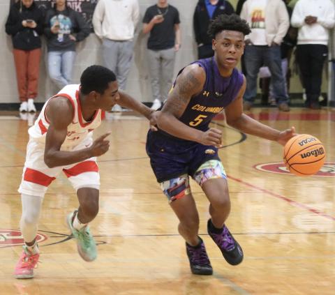 Columbia guard Jerome Carter dribbles up the court against Santa Fe last Friday. (JORDAN KROEGER/Lake City Reporter)