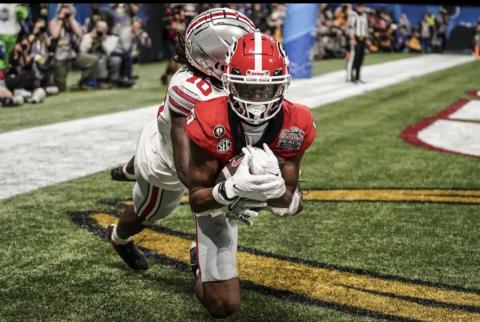 Georgia wide receiver Adonai Mitchell (5) makes a touchdown catch against Ohio State cornerback Denzel Burke (10) during the second half of the Peach Bowl NCAA college football semifinal playoff game, Saturday, Dec. 31, 2022, in Atlanta. Brynn Anderson/Associated Press)