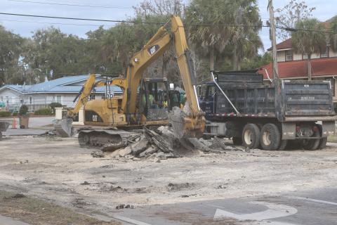 City crews clean up Lake Jeffery Road on Tuesday afternoon after repairing a broken water line on the road near the intersection with NW Orange Street. The line was broken by a contractor installing fiberoptic cables. (JAMIE WACHTER/Lake City Reporter)