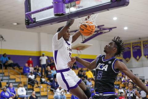 Columbia forward Seth Stockton dunks in front of Impact Christian Academy forward Jordan Mikell on Thursday night. (BRENT KUYKENDALL/Lake City Reporter)