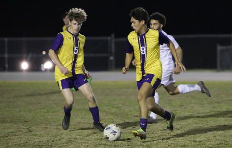 Columbia’s Bryson Kyi (9) dribbles the ball up the field alongside Johnathan Pineda (5) against Palatka on Jan. 17. (BRENT KUYKENDALL/Lake City Reporter)