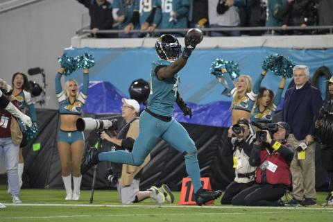 Jacksonville Jaguars linebacker Josh Allen returns a fumble for the game-winning touchdown against the Tennessee Titans on Saturday in Jacksonville. (PHELAN M. EBENHACK/Associated Press)