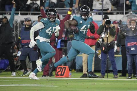 Jacksonville Jaguars linebacker Josh Allen (41) returns a fumble for a touchdown as defensive end Arden Key (49) covers against the Tennessee Titans on Saturday in Jacksonville. (PHELAN M. EBENHACK/Associated Press)