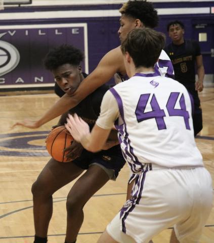 Columbia’s Ty’jahn Wright gets hit by Hurricanes defender Josh Hayes during Tuesday night’s game in Gainesville. (JORDAN KROEGER/Lake City Reporter)
