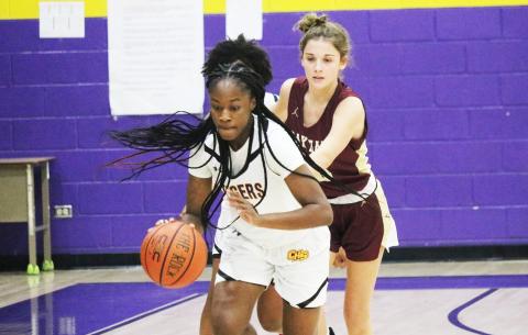 Columbia guard Eriel Baker pushes the ball up the court after stealing it away from Oak Hall guard Bella Gloriod on Friday night. (JORDAN KROEGER/Lake City Reporter)
