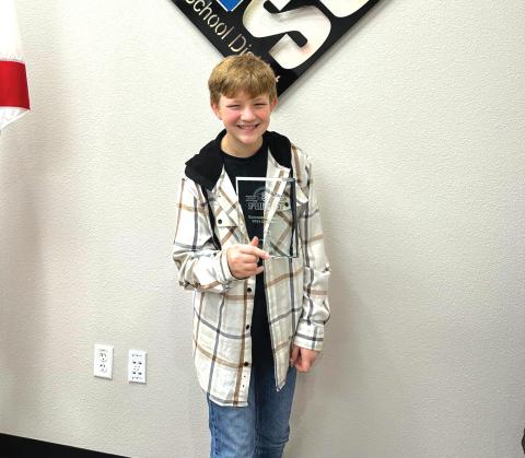 Suwannee Middle Schooler Bradley Harrison poses with his trophy after winning the SCSD Spelling Bee. (COURTESY)