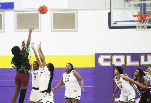 Madison County guard Janiyah McKnight makes the game-winning shot at the buzzer over Columbia guards Ryann Potter and Eriel Baker on Tuesday night. (JORDAN KROEGER/Lake City Reporter)