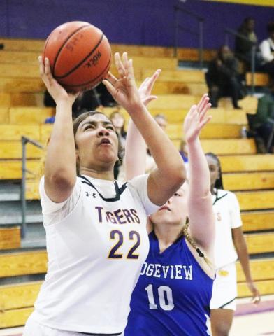 Columbia center Khalea Clark shoots while defended by Ridgeview guard Paetyn Miller on Jan. 23. (JORDAN KROEGER/Lake City Reporter)