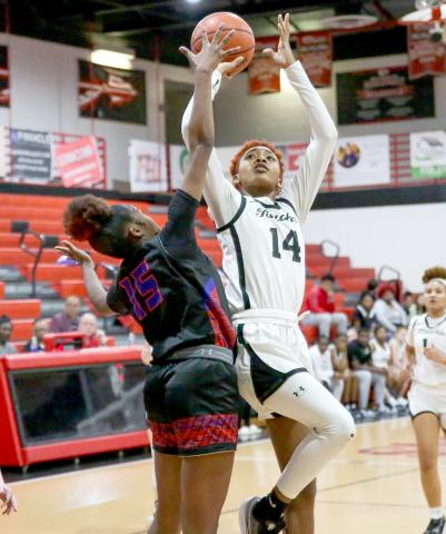 Fort White’s Isreal Hart shoots over Branford’s Zjamyah Wilson on Thursday night. (BRENT KUYKENDALL/Lake City Reporter)