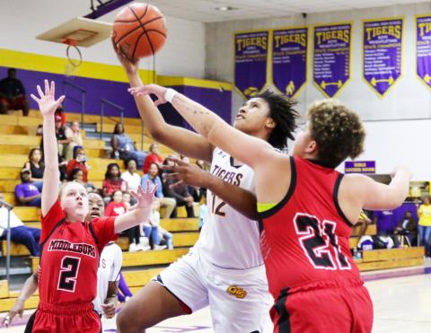 Columbia forward Jolena Gardner rises between Middleburg defenders Ruby Owen (2) and Cheyenne Jenkins (21) during Tuesday night’s District 2-5A quarterfinal. (BRENT KUYKENDALL/Lake City Reporter)