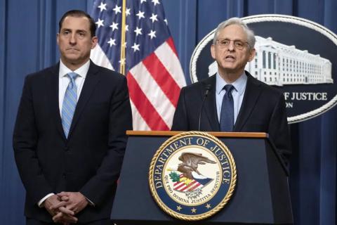 Attorney General Merrick Garland speaks during a news conference at the Department of Justice on Thursday in Washington, as John Lausch, the U.S. Attorney in Chicago, looks on. (MANUEL BALCE CENETA/Associated Press)
