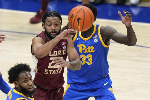 Florida State guard Darin Green Jr. gets off a pass with Pittsburgh center Federiko Federiko defending during Saturday's game in Pittsburgh. Florida State won 71-64. (GENE J. PUSKAR/Associated Press)