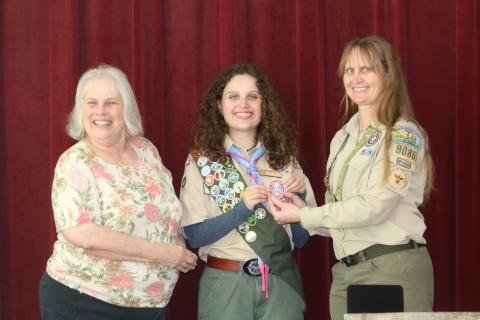Skylar Beichner center is presented with her Eagle Scout rank patch by her grandmother Ruth Kennedy (left) and mother Lodisca Beichner during a ceremony on Saturday. (TONY BRITT/Lake City Reporter)