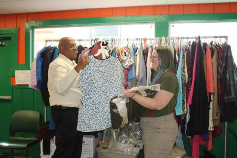 Philip Mobley (left), NorthStar Family Resource Center manager, hangs clothing at the facility Monday after with help from Christen Lancaster, NorthStar Community Center Community Research Coordinator. (TONY BRITT/Lake City Reporter)