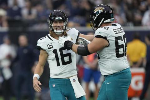 Jacksonville Jaguars quarterback Trevor Lawrence (16) and guard Brandon Scherff (68) celebrate a touchdown against the Houston Texans on Sunday in Houston. (DAVID J. PHILLIP/Associated Press)