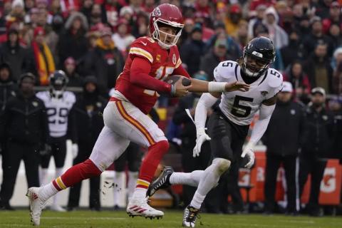 Kansas City Chiefs quarterback Patrick Mahomes runs out of the pocket as Jacksonville Jaguars safety Andre Cisco defends during Saturday's divisional playoff game in Kansas City, Mo. (ED ZURGA/Associated Press)
