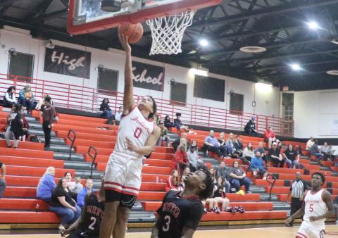 Fort White guard Tafari Moe rises for a layup over Lafayette’s Amarie Fleming on Friday night. (MORGAN MCMULLEN/Lake City Reporter)