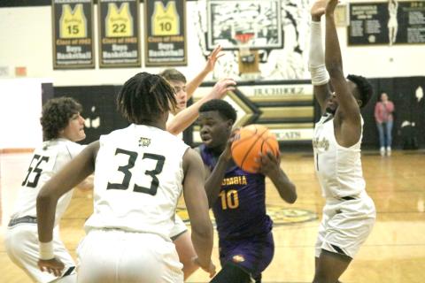 Columbia guard Isaac Broxey drives to the basket surrounded by Buchholz defenders on Tuesday night. (JORDAN KROEGER/Lake City Reporter)