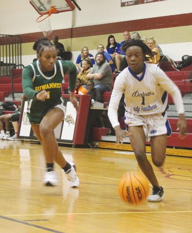 Palatka’s Jhane Fountain finds an alley to the basket as Suwannee’s Janeah Mitchell tries to keep up with her in Thursday night’s District 5-4A semifinal. (MARK BLUMENTHAL/Palatka Daily News)