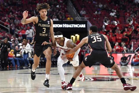 Florida State guard Matthew Cleveland (35) tries to strip the ball away from Louisville guard El Ellis (3) during Saturday’s game in Louisville, Ky. (TIMOTHY D. EASLEY/Associated Press)