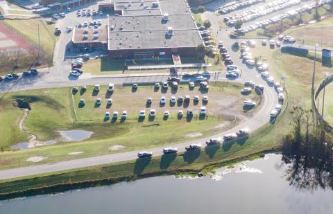 Law enforcement vehicles line the road into Columbia High School on Thursday morning after a call of an armed person on campus. The armed person turned out to be a JROTC cadet bringing back a non-functioning training rifle. (RAY CARPENTER/Special to the Reporter)