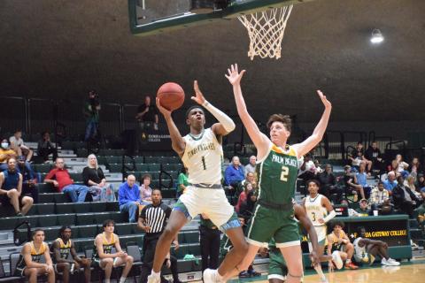 FGC guard Jeremiah Barze goes up for a shot while being defended by Palm Beach State College guard Ryan Moore on Wednesday at the Howard Center. (COURTESY OF FGC)