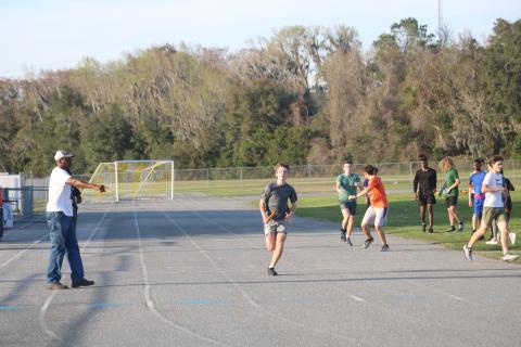 Columbia High track and field head coach Lawrence Davis (left) instructs runners during a Wednesday afternoon practice at the track in Tiger Stadium. (TONY BRITT/Lake City Reporter)