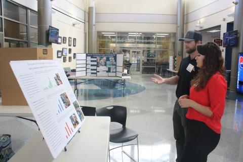 Tristian Huff (from left) and Stevee Boyd look over science fair projects as 2023 Suwannee Valley Regional Science and Engineering Fair judges on Thursday after at the Wilson S. Rivers Media Center on the Florida Gateway campus. Winners will be announced today at the Levy Performing Arts Center. (TONY BRITT/Lake City Reporter)