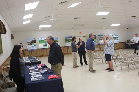 Barbara Cartwright (left), with the Florida Division of Emergency Management, talks to Mike Null during a meeting regarding new FEMA flood maps on Thursday night at the Westside Community Center. (TONY BRITT/Lake City Reporter)