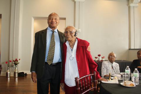 Merril Tunsil stands with his mother, retired educator Joyce Parnell Tunsil, who was recognized as being 95 years old at the Unsung Heroes program. Her sister Mildred Veronica Parnell Tunsil, (sitting background) was also recognized for being older than 90, as well as her brother Donal Parnell, who was siting at the table, for being 99 years old. (TONY BRITT/Lake City Reporter)