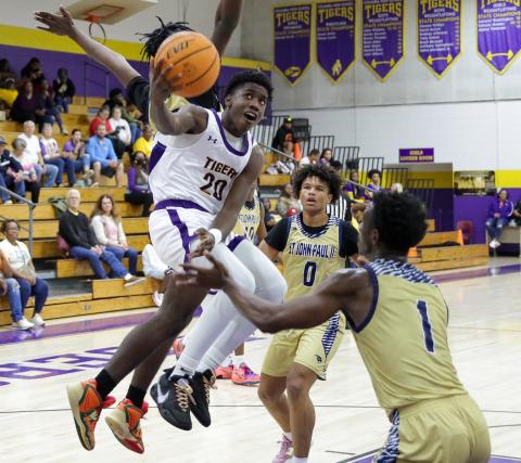 Columbia guard Jayden Jackson flies between St. John Paul II defenders to get up a layup on Thursday night. (BRENT KUYKENDALL/Lake City Reporter)