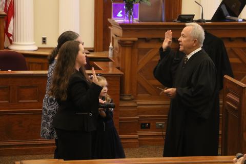 Circuit Court Judge David Fina (right) administers the oath of office to Suwannee County Judge Jennifer Kuyrkendall Griffin on Wednesday as Griffin’s daughter, Kendall, and mother look on. (MORGAN MCMULLEN/Lake City Reporter)