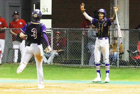 Columbia shortstop (2) Brayden Thomas celebrates as outfielder Carston Palmer (3) scores on an error against Santa Fe on Thursday night. (MORGAN MCMULLEN/Lake City Reporter)