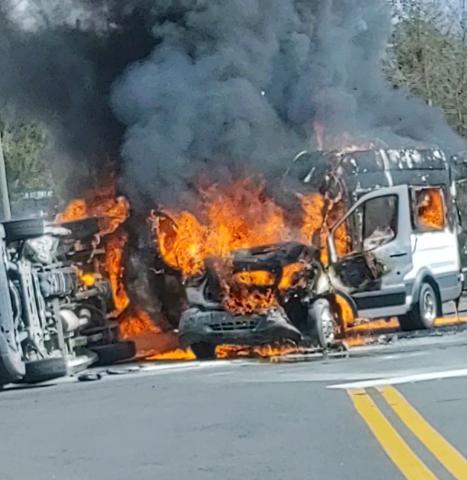 Two vans burst into flames after colliding on U.S. Highway 41 North at the intersection with NW Moore Road on Wednesday afternoon. (COURTESY)