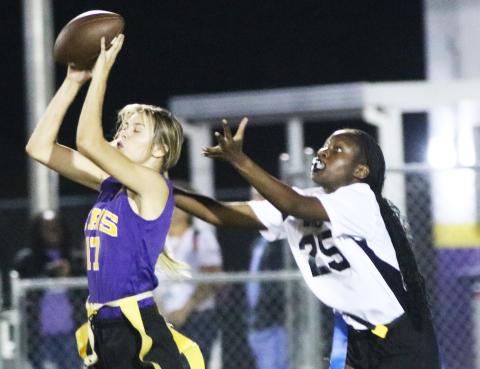 Columbia safety Mia Brasel intercepts her third pass of the night in front of Baker County receiver Samuriah Major on Thursday night. (JORDAN KROEGER/Lake City Reporter)