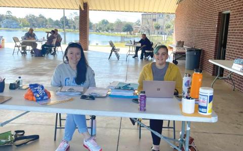 Volunteers sit at a makeshift desk at Wilson Park during a Florida drivers license restoration event in 2022. (COURTESY)